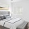 a bedroom with a bed and a fan