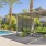 a swimming pool with chairs and palm trees