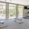 a room with exercise equipment and chairs