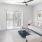 a living room with a white couch and a white wall